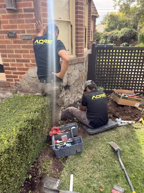 ACRE crew digging out an old valve manifold (ACRE job photo)